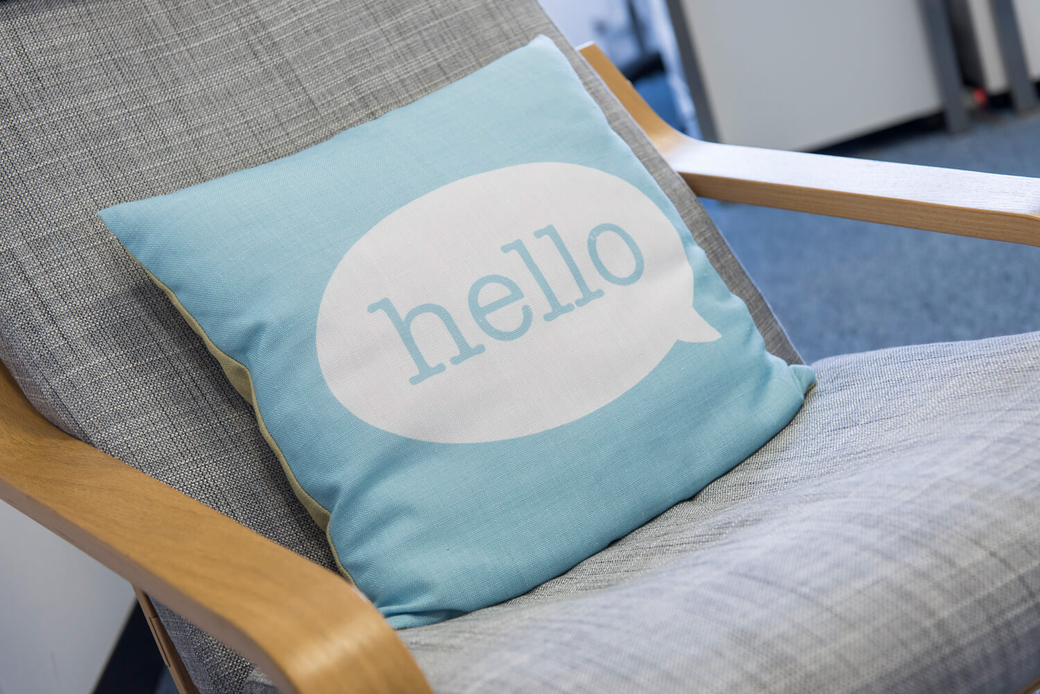 Chair with 'Hello' pillow